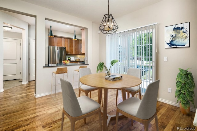 1067 Uinta Way Unit 1067, Denver, CO 80230 - dining room with light wood-style flooring and a chandelier