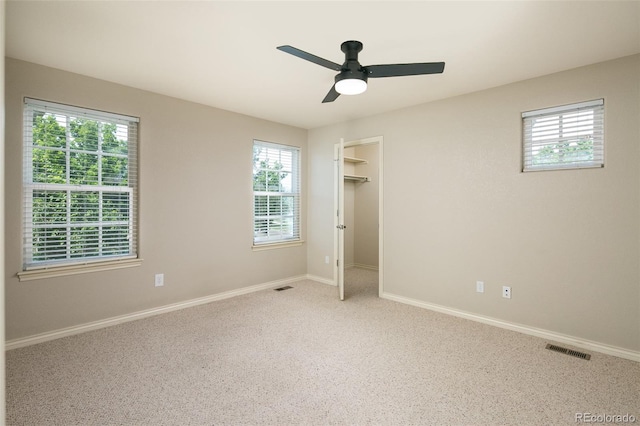 1067 Uinta Way Unit 1067, Denver, CO 80230 - unfurnished bedroom with multiple windows, carpet, ceiling fan, and a spacious closet