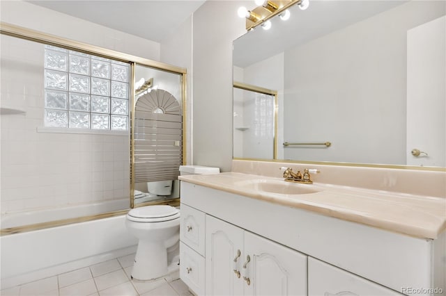 full bathroom with tile patterned flooring, vanity, enclosed tub / shower combo, and toilet