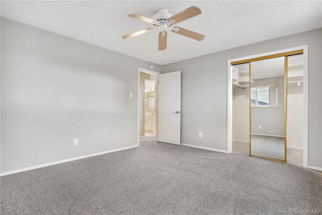 unfurnished bedroom with a textured ceiling, carpet floors, a closet, and ceiling fan