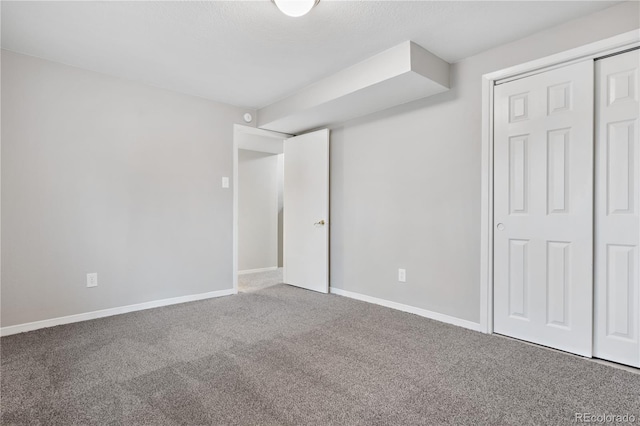 unfurnished bedroom with carpet flooring and a closet