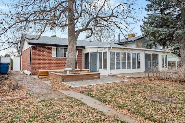 back of house with a patio area and a sunroom