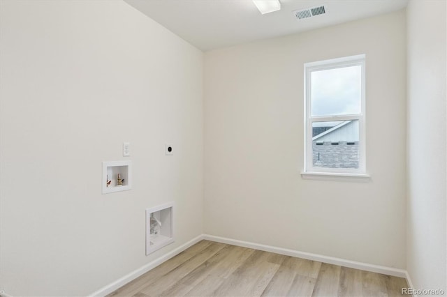 8205 Cokedale Cir, Littleton, CO 80125 - clothes washing area featuring hookup for an electric dryer, light wood-style floors, hookup for a washing machine, and baseboards