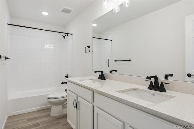 8205 Cokedale Cir, Littleton, CO 80125 - full bathroom with wood finished floors, toilet, double vanity, shower / bath combination, and recessed lighting