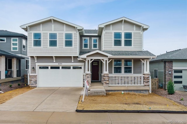 8205 Cokedale Cir, Littleton, CO 80125 - view of front facade with covered porch, an attached garage, driveway, and stone siding