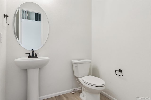 8205 Cokedale Cir, Littleton, CO 80125 - bathroom with wood finished floors, toilet, and baseboards