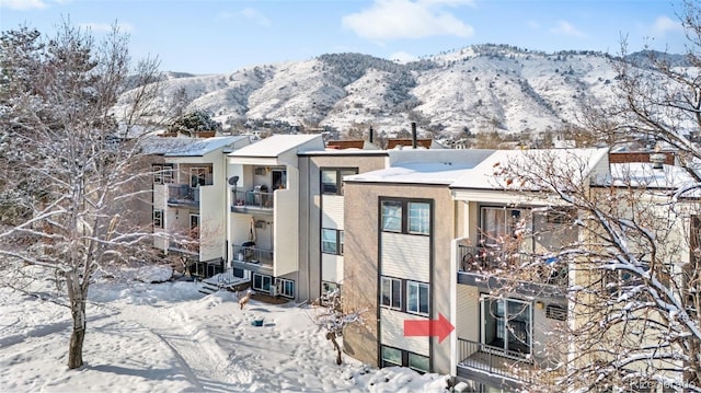 snow covered building with a mountain view