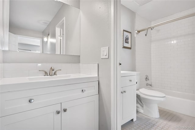 full bathroom featuring vanity, tile patterned flooring, tiled shower / bath combo, and toilet