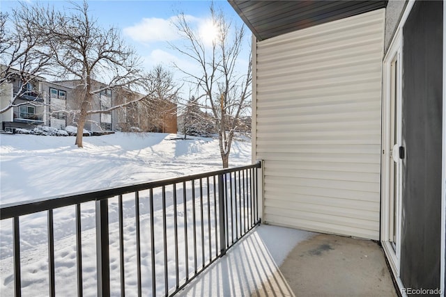 view of snow covered back of property