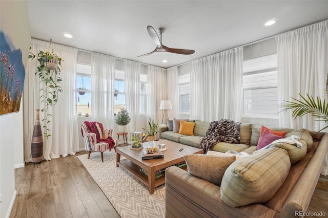 interior space with ceiling fan and light hardwood / wood-style floors