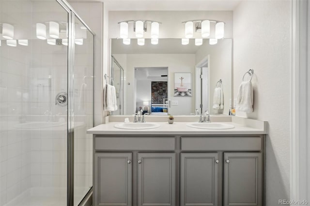 bathroom with a shower with door and vanity