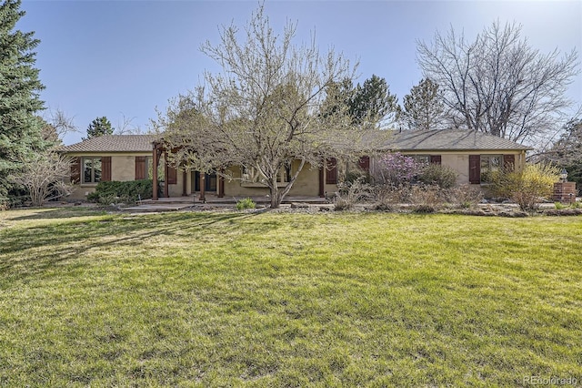 ranch-style house with a front yard and stucco siding