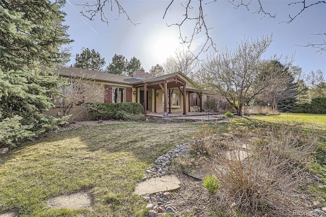 single story home with a porch and a front yard