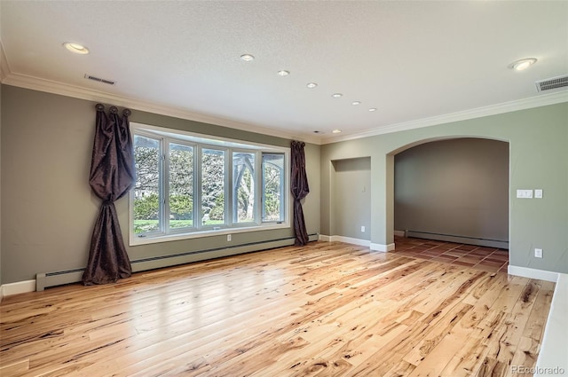 empty room featuring visible vents, ornamental molding, arched walkways, a baseboard radiator, and light wood-style flooring