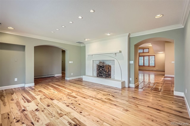 unfurnished living room featuring arched walkways, crown molding, and hardwood / wood-style flooring