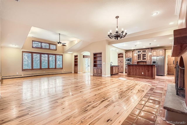 unfurnished living room featuring light wood-style flooring, arched walkways, recessed lighting, ceiling fan with notable chandelier, and a baseboard radiator