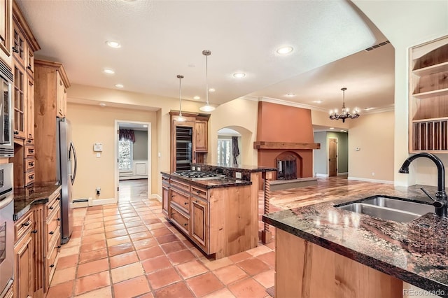 kitchen featuring recessed lighting, appliances with stainless steel finishes, dark stone counters, and a sink