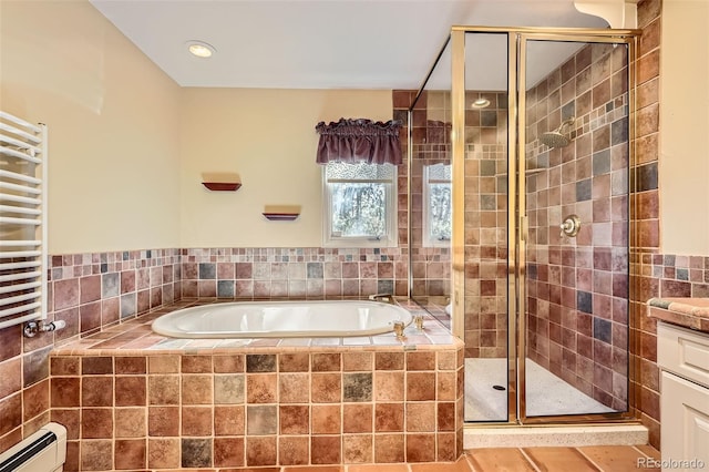 full bath featuring a baseboard heating unit, a garden tub, a stall shower, and radiator