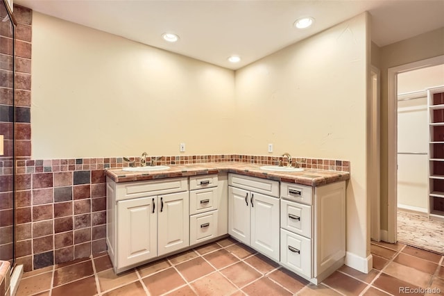 full bathroom with recessed lighting, a sink, and tile walls