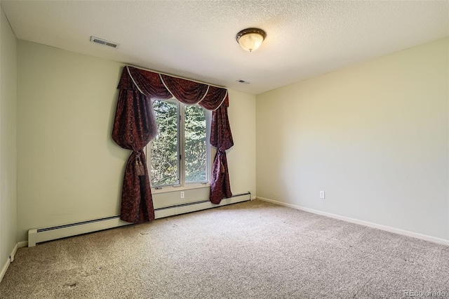 carpeted empty room with baseboards, visible vents, and a textured ceiling