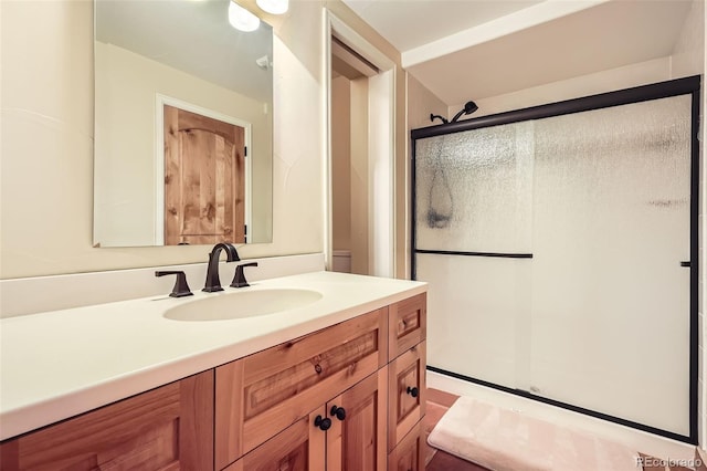 full bath with a shower stall and vanity