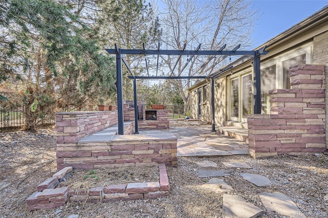 view of yard with a pergola, an outdoor stone fireplace, a patio, and fence