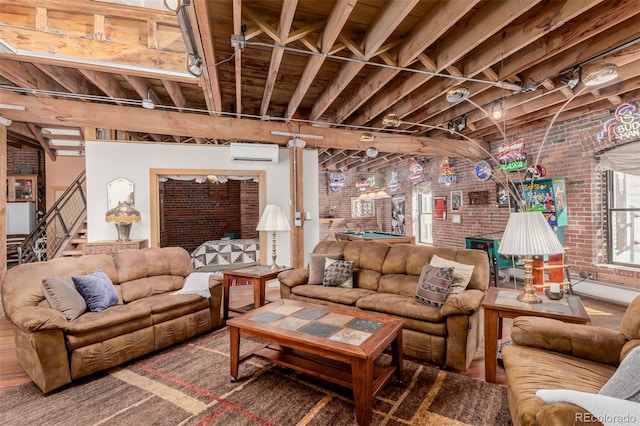 living room with beamed ceiling, pool table, a wall mounted AC, and brick wall