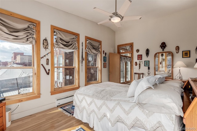 bedroom with light wood-type flooring, ceiling fan, and baseboard heating