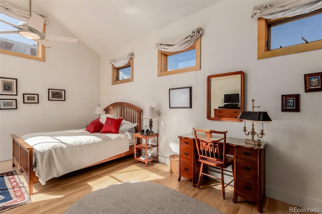 bedroom featuring ceiling fan, light hardwood / wood-style flooring, and high vaulted ceiling