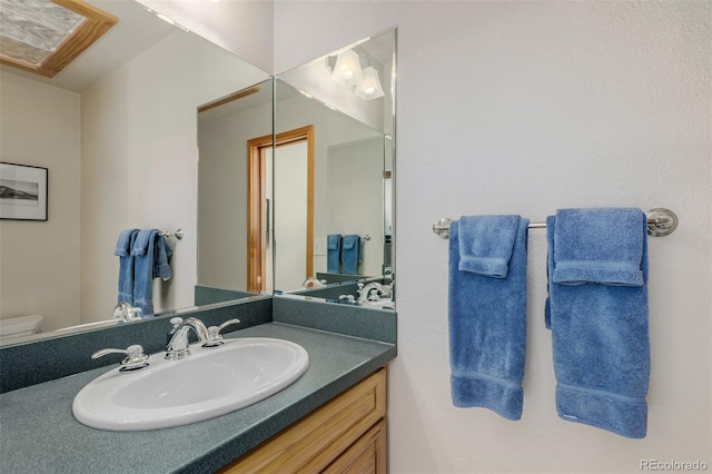 bathroom featuring vanity and toilet