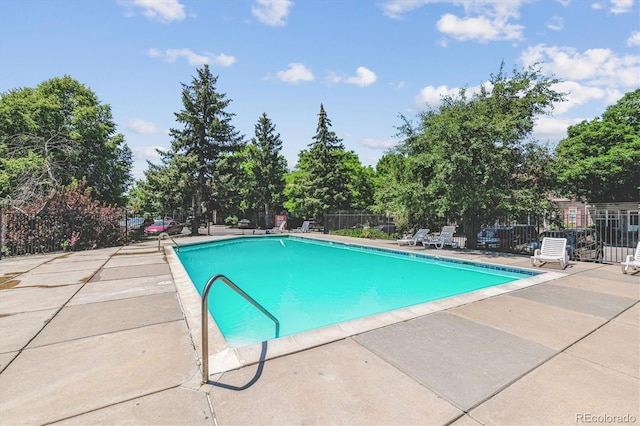 12059 E Hoye Dr, Aurora, CO 80012 - community pool with a patio and view of scattered trees