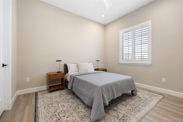 bedroom featuring hardwood / wood-style floors and ceiling fan