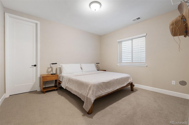 carpeted bedroom with baseboards and visible vents