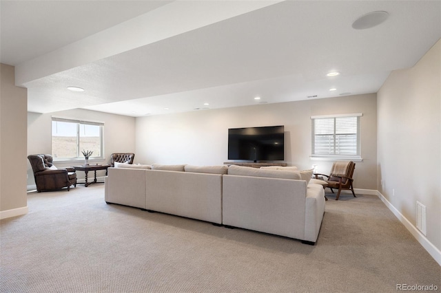 living room with recessed lighting, light colored carpet, visible vents, and baseboards