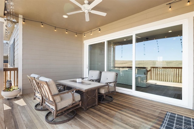 wooden deck featuring ceiling fan