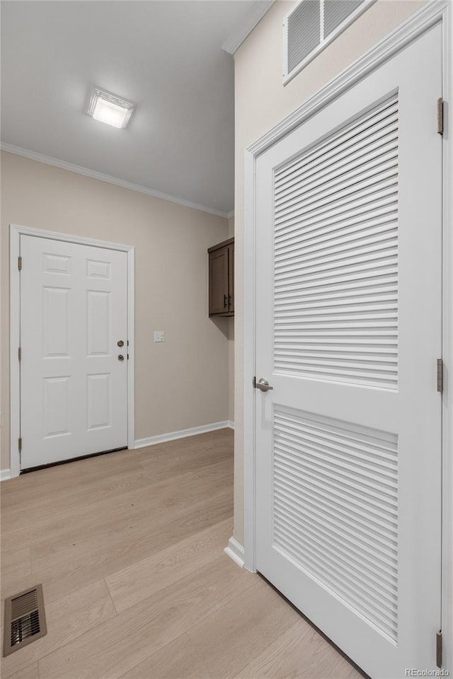 entrance foyer with light wood-type flooring and ornamental molding