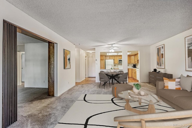 carpeted living room with a textured ceiling and ceiling fan