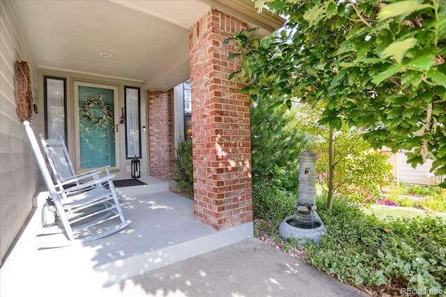 6112 Alkire Ct, Arvada, CO 80004 - entrance to property featuring brick siding and a porch