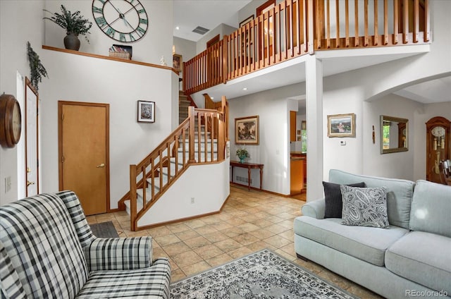 6112 Alkire Ct, Arvada, CO 80004 - living room with a towering ceiling, stairway, arched walkways, and tile patterned floors