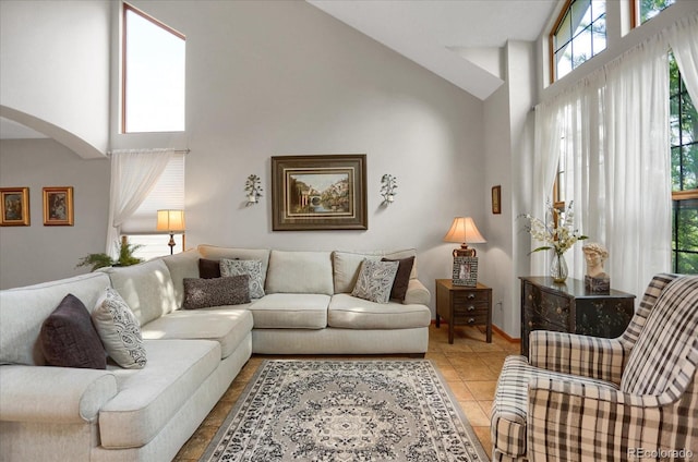 6112 Alkire Ct, Arvada, CO 80004 - living room with a high ceiling, arched walkways, and light tile patterned flooring