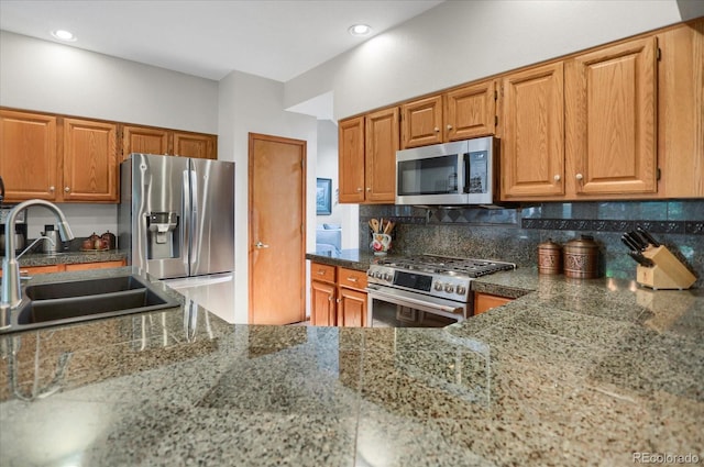 6112 Alkire Ct, Arvada, CO 80004 - kitchen featuring appliances with stainless steel finishes, backsplash, brown cabinetry, and recessed lighting