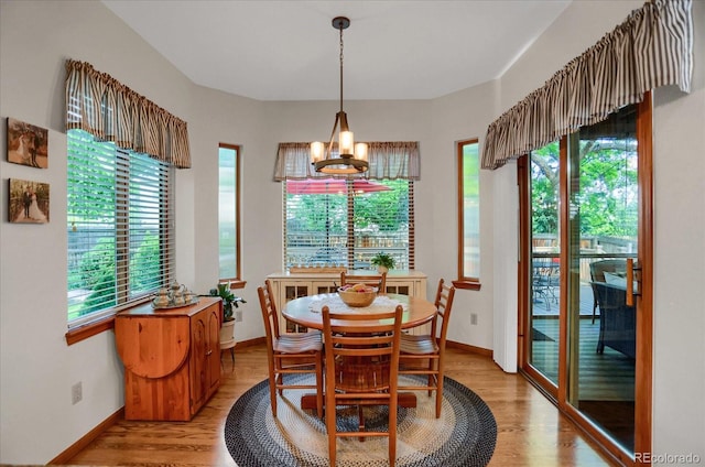 6112 Alkire Ct, Arvada, CO 80004 - dining area with light wood-style flooring and a chandelier