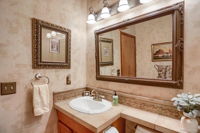 6112 Alkire Ct, Arvada, CO 80004 - half bath featuring vanity and wallpapered walls