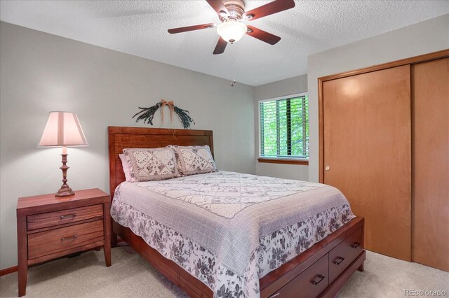 6112 Alkire Ct, Arvada, CO 80004 - bedroom with light colored carpet, a closet, a textured ceiling, and ceiling fan
