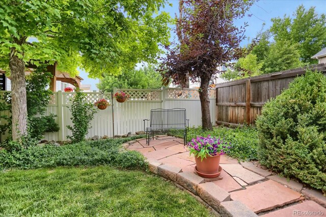 6112 Alkire Ct, Arvada, CO 80004 - fenced backyard with a patio area