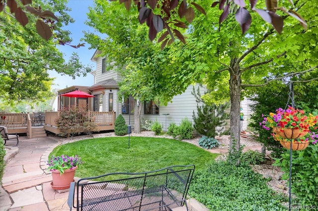 6112 Alkire Ct, Arvada, CO 80004 - view of green lawn with a wooden deck and a patio