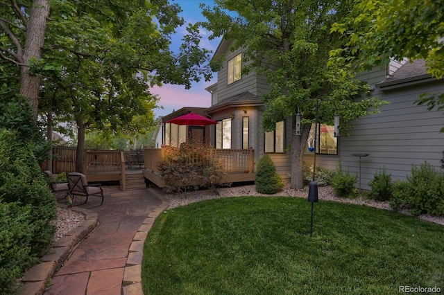 6112 Alkire Ct, Arvada, CO 80004 - view of grassy yard featuring a wooden deck and a patio area