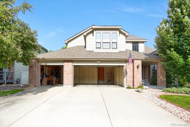 6112 Alkire Ct, Arvada, CO 80004 - view of front facade with brick siding, concrete driveway, and roof with shingles