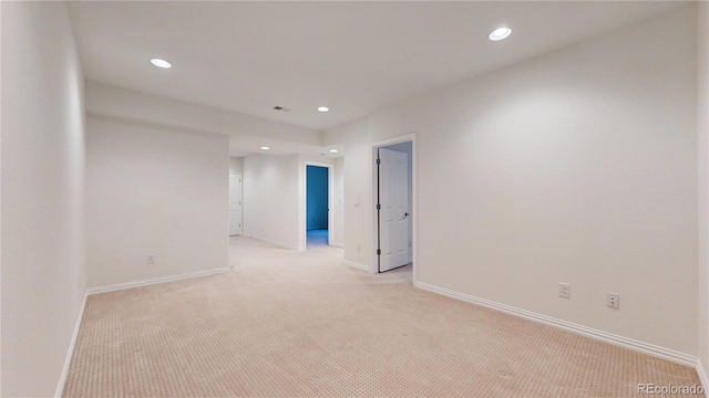 empty room with recessed lighting, baseboards, and light colored carpet