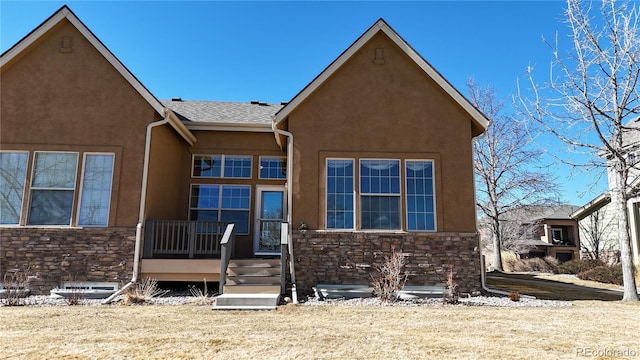 view of front of property with stone siding, a shingled roof, and stucco siding